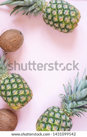 Pineapples on a pink background. Summer composition. Tropical fruits, pineapple. Summer concept. Flat lay, top view, copy space