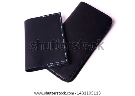 Black handmade leather man wallet and passport cover isolated on white background. Purse and cover are closed. Stock photo of luxury businessman accessories.