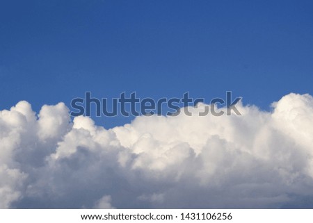Blue sky with clouds background. Sky with cumulus clouds. Big air clouds in the blue sky. Selective focus. Copy space.