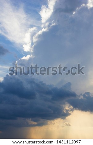 vertical cumulus clouds on the beautiful sunset summer sky