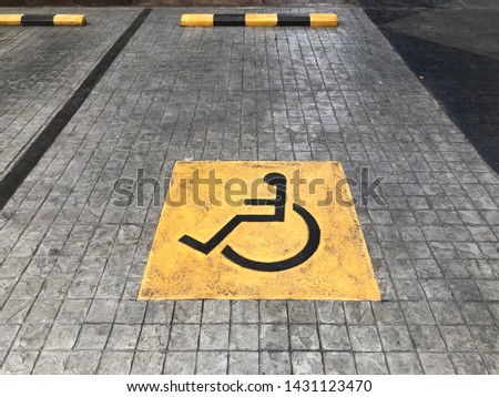 Disabled parking with symbol sign on the concrete stamp floor.