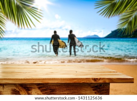 Desk of free space and summer time on beach 