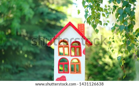 decorative wooden house in garden, green abstract natural background. Mortgage property insurance, home concept. Symbol of happiness, family, Real estate concept. Eco Friendly House, Eco home