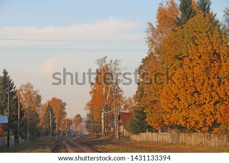 Autumn landscape with a view of the village in Russia