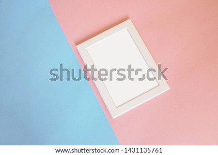 Mock up frame : Blank white color picture frame template for place image or text inside on pastel pink and blue colorful background