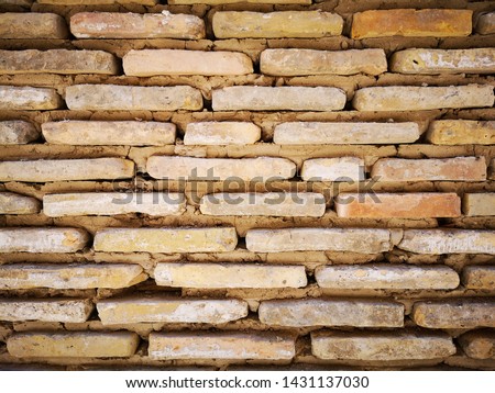 Old handmade traditional yellow brick wall 