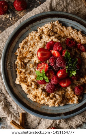 Delicious breakfast with fresh berries, cinnamon and mint