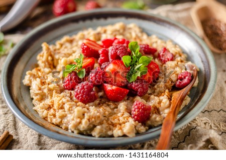 Delicious breakfast with fresh berries, cinnamon and mint