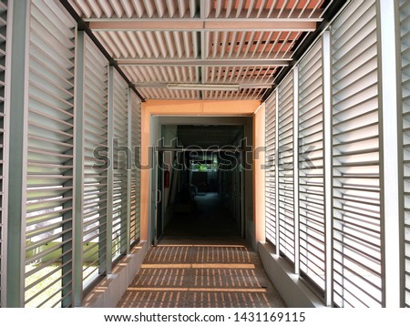 Silver aluminum louver on the wall for ventilation and lighting with horizontal pattern. Exterior design,
Energy saving concept.  Royalty-Free Stock Photo #1431169115