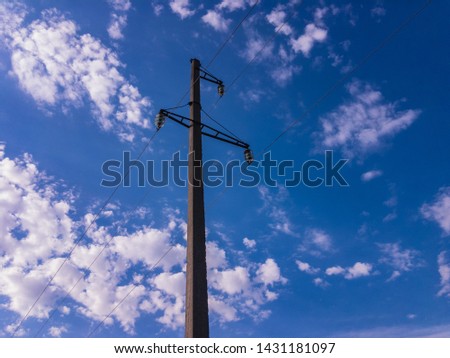blue sky with white clouds and high voltage line pylon