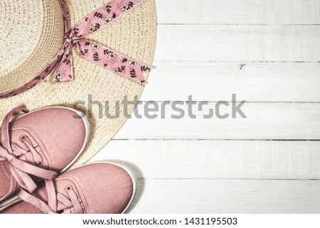 Flat lay of women's summer shoes and hat on white wooden background, vintage toned photo with copy space. Summer holidays concept.