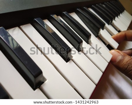 Musician playing keys in a musical keyboard
