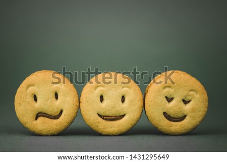 biscuit cookies with different emotions on a dark background