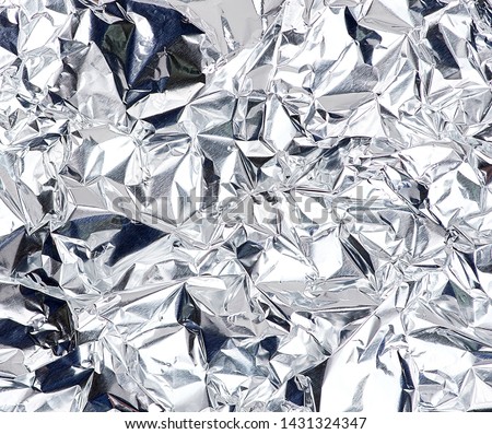 crumpled silver foil sheet, full frame, close up