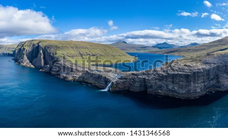 Bosdalafossur waterfall on Vagar island coastline aerial view, Faroe Islands