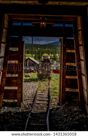 An old mining cart sits abandoned on a rail track on display at the south park city museum in Fairplay Colorado Royalty-Free Stock Photo #1431365018
