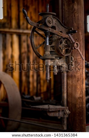 A historic drill press on display at the south park city museum in Fairplay Colorado Royalty-Free Stock Photo #1431365384