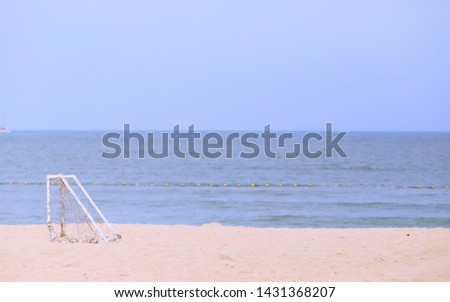 Football goal closeup on sandy beach and blur ocean view