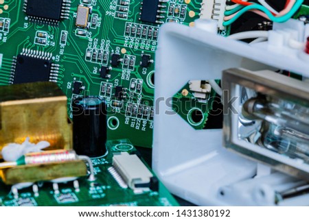A Macro image of Circuit boards and other components of a broken-down photographer’s flash in repair.  The components are in sharp focus at center frame and gradually become softer away from center.