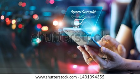 Woman using mobile smart phone, online payment, banking and online shopping in the night light colorful background Royalty-Free Stock Photo #1431394355