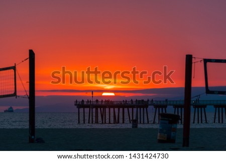 The hamburger sun. Beautiful sunset scene of Hermosa beach nearby Los Angeles California.Beach house resident calls  the cloudy sun the hamburger sun. We could see amazing sunset scene at cloudy day.