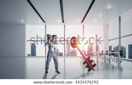 Determined businessman in modern interior breaking with violin stone key figure