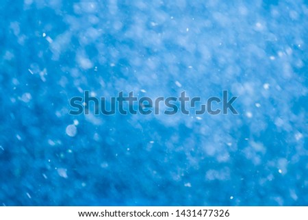 Abstract rain fall and bokeh background in blue color. Un-focus on this image.