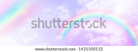There are clouds and sky with rainbow as pastel background.