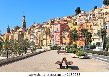 View of promenade and old medieval town with multicolored houses of Menton on french riviera in France. Royalty-Free Stock Photo #143150788