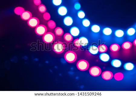 Duotone Abstract bokeh lights and reflections. Festive background of 80s colors.