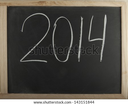 Blackboard with number "2014" written with chalk