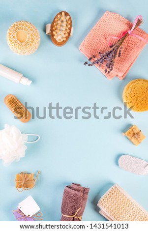 Frame of Scrub peeling brush body scrubber massager loofah bar of soap on blue