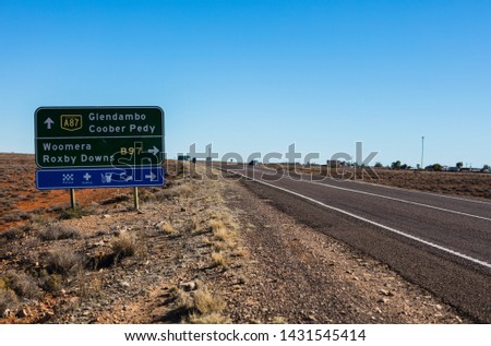 A roadside sign pointing to the side road which will take you to the outback towns of Woomera and Roxby Downs, otherwise you will end up in Coober Pedy eventually.