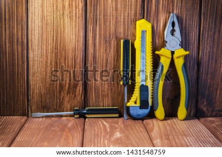 Hand tool on dark wooden background for homework. Kit for household works or for a locksmith.