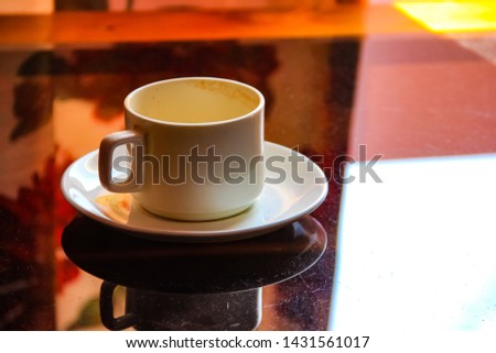 empty cappuccino cup on wood surface
