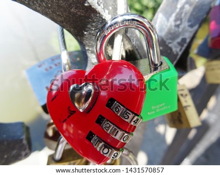 Red heart shaped padlock on a bridge. Conceptual love or valentine background