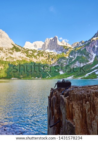 Vintage film photo camera. Back view, close up photo. Against the background of the Mountain Landscape