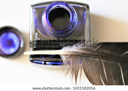 quill pen and inkwell on white background