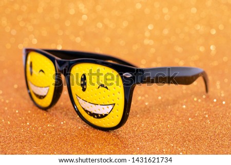 smile masquerade glasses isolated on a golden background.