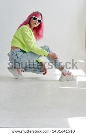 woman in glasses with pink hair in stylish clothes