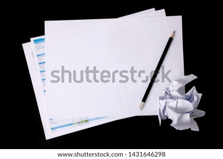 Blank notepad and spreadsheet with penceil. Blank Paper on black background.Copy space