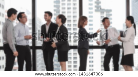 Blurred photography of asian business group relax talking at office background.