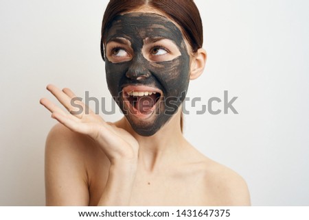 joyful woman in a cosmetic mask