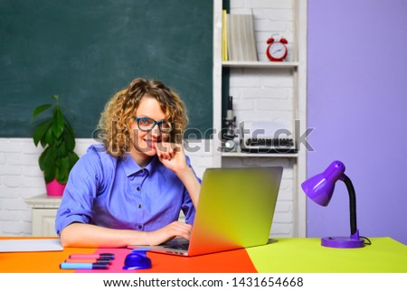 Back to school. Smiling teacher working with laptop. Learning and education concept. Smiling teacher in glasses. Homework. E-learning.