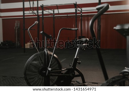Exercise bikes for cardio in red color crossfit gym.