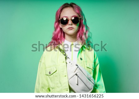 woman in stylish clothes with pink hair in glasses