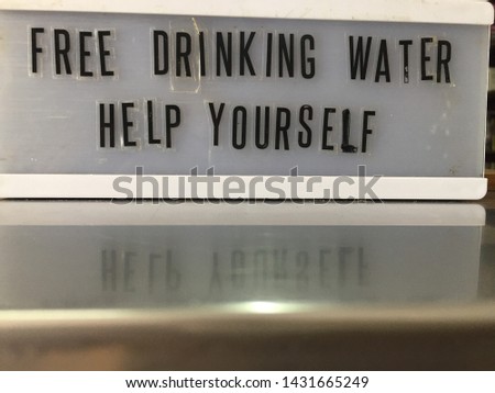 Free drinking water help yourself sign