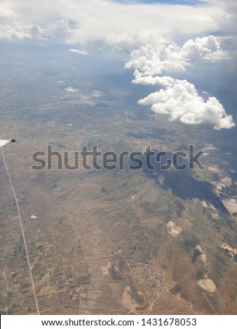 The piece of airplane wing and Turkey seen from above the clouds, pictures made on the small window on the right side of the plane