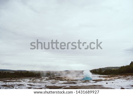 Stages of the eruption of the famous Strokkur Geyser In Iceland on a cold cloudy afternoon. Giant blue bubble right before the eruption