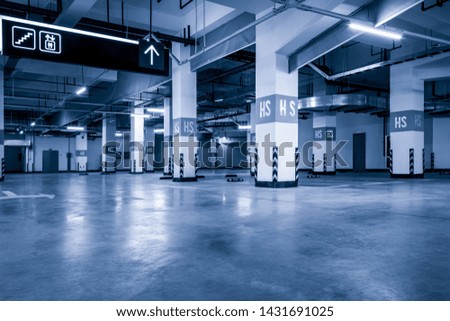 Large parking lot on the ground floor of a modern business building